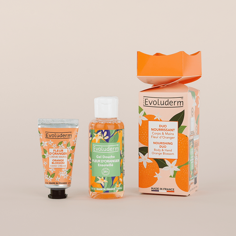 Duo Nourrissant Corps & Mains présenté sous forme de crackers, comprenant un gel douche et une crème mains à la fleur d’oranger